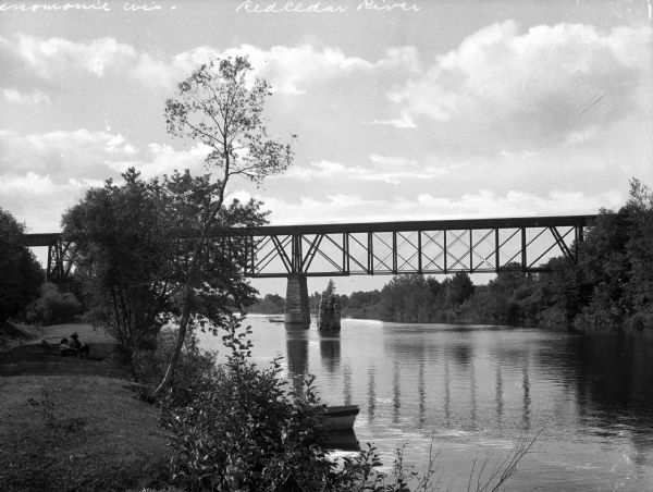 A railroad bridge crosses over Red Cedar River.