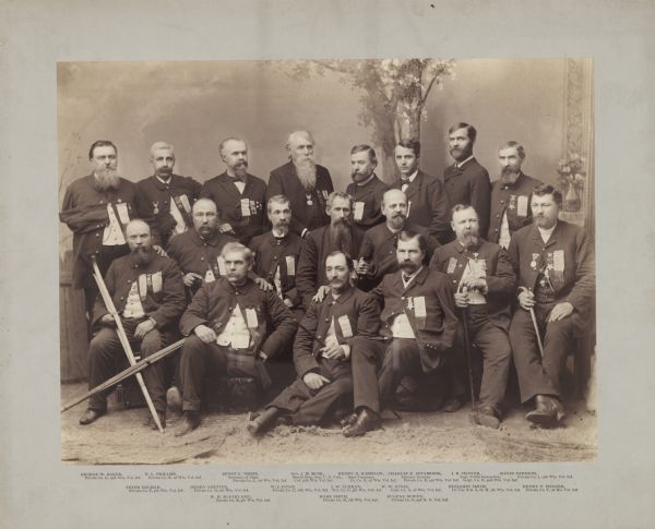 Group portrait of officials and employees of the Wisconsin state administration, who made up Governor Jeremiah M. Rusk's "one-armed and one-legged" staff of Grand Army of the Republic Civil War veterans.