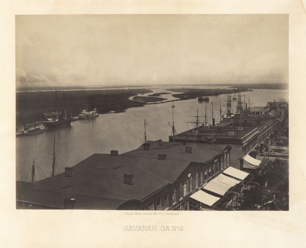 Elevated view over storefronts and the river.<br>Plate 50</br>