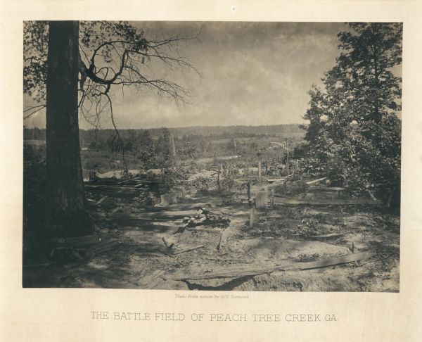 The aftermath of the Battle of Peach Tree Creek. Union graves are in the foreground, with a field in the middle, and a forest in the background.<br>Plate 34</br>
