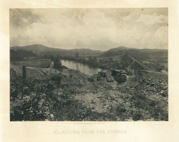 View towards the Allatoona Pass from behind earthworks overlooking the Etawah River. A railroad bridge crosses the river on the right.<br>Plate 24</br>