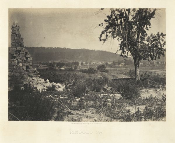 View of Ringgold in the far distance. A tree and pile of rubble, perhaps the remains of a fireplace, in the foreground.<br>Plate 17</br>