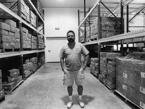 CEO Joe Widmer stand in the 40-degree cold storage room where Widmer's ages their award winning Cheddar, Brick, and Colby Cheese.