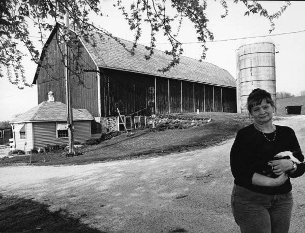 This barn is at 1776 Hocheim Road. Lois Benter and her cat C.D. posed for this picture. She acquired C.D. on Christmas Day - hence C.D.