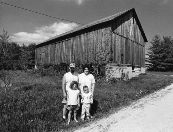 John and Tammy Roecker with their children Cayla 3, Courtlyn 4, and (not pictured) Cody & Cassie. They live across the road from this barn at W4161 Mountain Road.