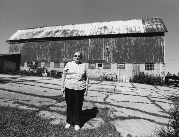 Rosie Weninger stands in front of this barn at W371 Allen Road (section 25). Rosie's husband, Myron, passed away August 21, 2001. Myron's grandfather, George, had this barn built in 1898.
