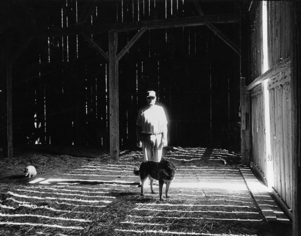 Larry Luhn and his dog, Dingo, were photographed in the barn hayloft. The last time cows were milked here was in 1995.
