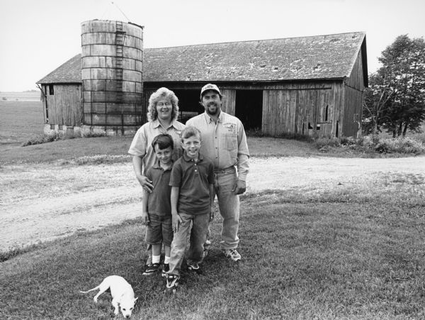 Brian and Lisa Adelmeyer and sons, Josh (9) and Joey (6), and Whitey the dog, live at W236 Allen Rd (Section 24). The silo is a Martin silo dating to 1950.