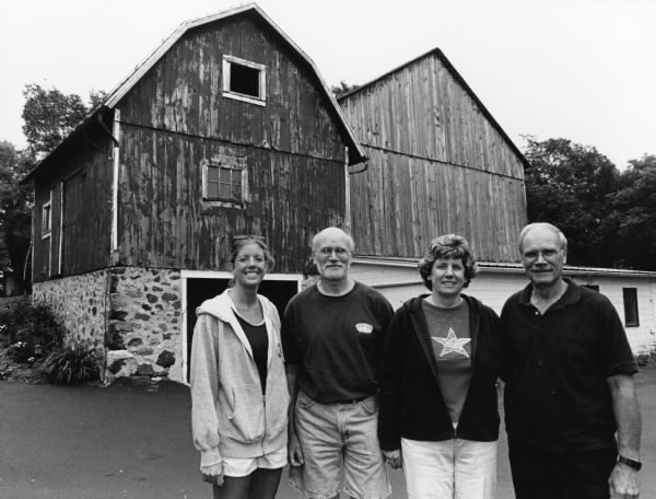 Tom and Leslee Kovalaske, their daughter Christina, and Tom's brother Jim pose in front of the barn at N8348 Hwy 175 (Section 23).