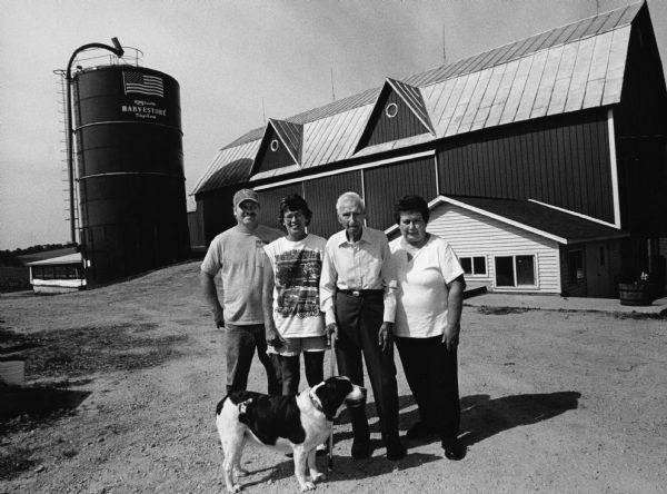 Mike and Jody Battisti (left) live at W2369 Zion Church Rd (Section 32). This farm was in the Zimmerman family from 1855-1994. Erhard Zimmerman and daughter-in-law, Carla Zimmerman, join the Battistis in front of this barn which was built in 1903.