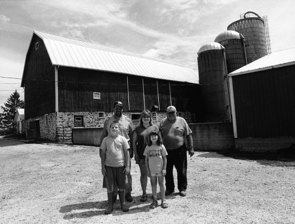 The Fink Farm at W2331 Elm Dr. John and Vicky Fink and their children, Brandon and Brittany, pose with John's father, Roger.