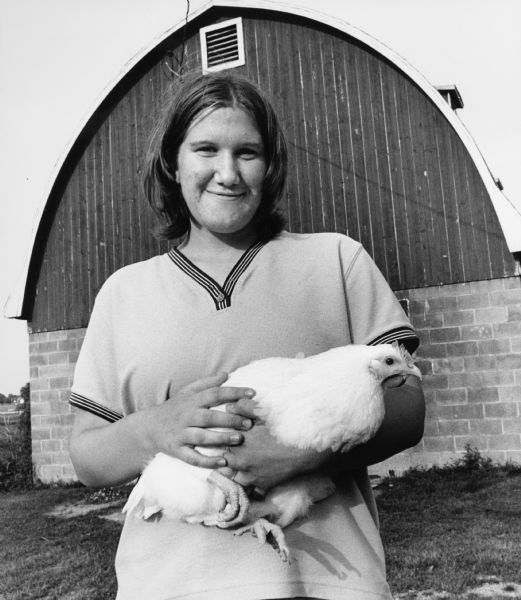 Heidi Lichtenberg shows off her pet, Wanda, which she plans to enter in competition at the Dodge County Fair. Heidi says, "Chicken is not on my menu!"