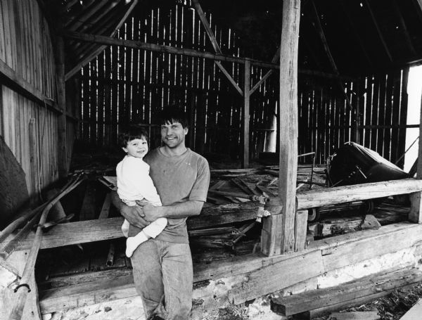 Michael Schneider and his son, Matthew, pose in the hayloft of the old barn.