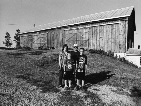Dan and Diane Krueger pose with sons, Jimmy, and Jerry (the tallest), on their property at N8990 Sunnyview Road (Section 7).