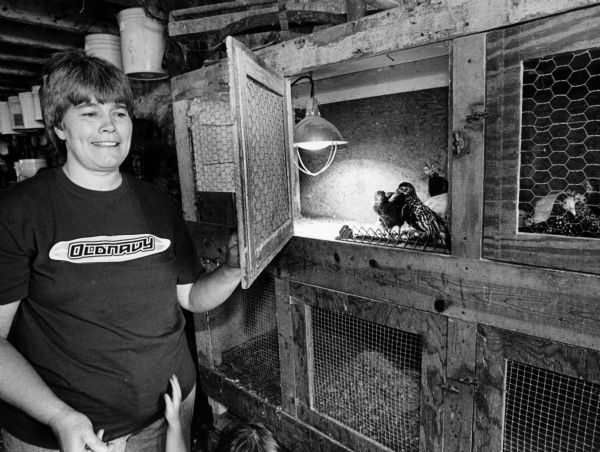 Marge Stommel shows off some chickens that she is raising.