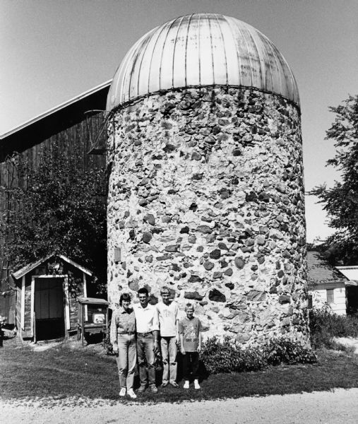 The Todd Bodden family poses by this wonderful, old silo, which was built in 1910. One can only imagine how many field stones were used in the 12-inch thick sides of this silo.
