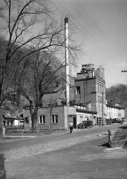 An exterior view of the old brewery at Potosi. A man is walking down the street toward the building.