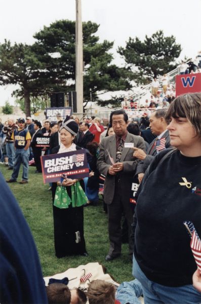 Supporters at Bush-Cheney rally. A member of the Hmong community holds a Bush-Cheney sign.