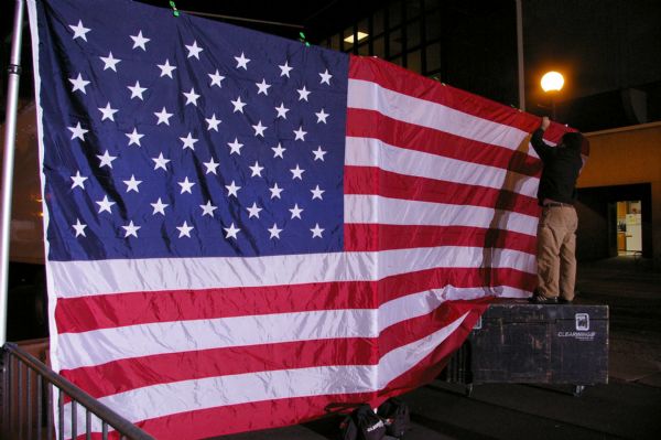 Man installing large American flag.