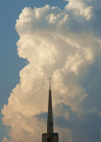 Cathedral steeple in a cloudy sky.