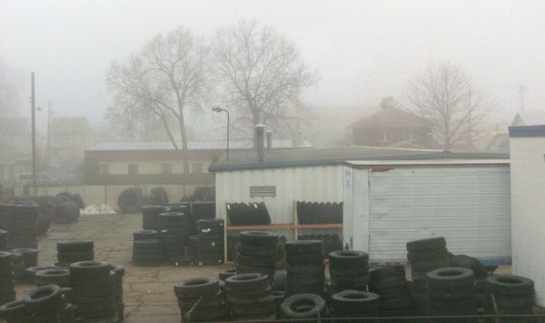 Elevated view of a tire yard on a foggy day.