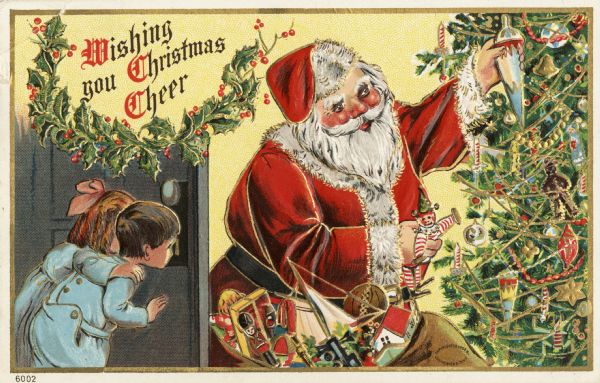 Holiday postcard of Santa Claus, wearing his traditional red, fur-trimmed suit and hat, and black belt. He has a sack full of toys and is placing some of them on a Christmas tree. Two children wearing pajamas are peeking through the keyhole of a door to spy on him. The text: "Wishing you Christmas Cheer" is in the upper left corner inside a swag of holly. Chromolithograph. The entire image is embossed.