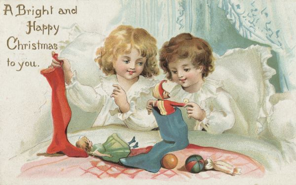 Holiday postcard of two children, one with blonde hair and one with  brunette hair. They are in bed wearing their pajamas while emptying their Christmas stockings. On the bed lays a doll, two balls and a piece of candy. Another doll, a jester, is being pulled out of a stocking. Chromolithograph. The entire image is embossed.