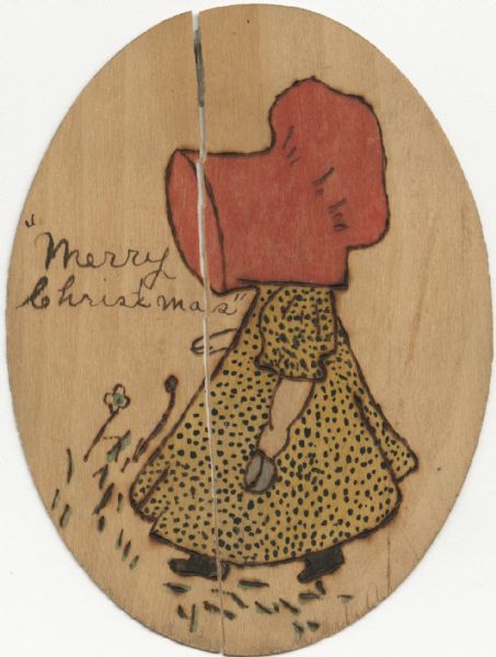 Holiday card, hand-painted on an oval piece of wood. Image is of a little girl in profile wearing a yellow dress with black polka dots, and a red bonnet. She is holding a blue cup in her left hand. Grass and flowers are on the ground. "Merry Christmas" is handwritten on left side.