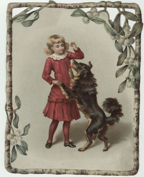Holiday card featuring a girl and her dog. The girl is wearing stockings, a red dress with a white lace collar, and black shoes. The dog is standing upright on its hind legs and has its front paws on her waist. The image has a frame of branches and mistletoe. Chromolithograph. Outside of card and left and right corners are die cut.