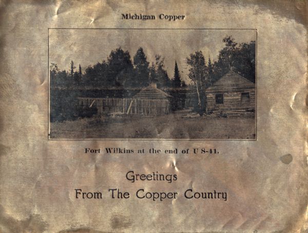 Holiday card printed on a sheet of copper. It has a scene of log buildings, a stockade fence, and woods in the background. Above is the text "Michigan Copper," below "Fort Wilkins at the end of US-41. Greetings from Copper Country." Letterpress, black ink.