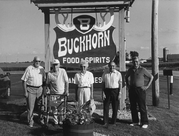 "The Buckhorn Restaurant is located several miles southeast of Fox Lake on Cty. Tr. A." From left to right; John Bodden, Ralph Widmer, Shirley Widmer, Rudy Heinecke, and Ralph "Buddy" Ruecker. 