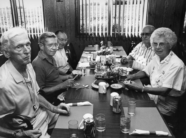 "We dine at the Buckhorn Restaurant. A half order of Lake Perch is only $5.00." From left to right; Ralph Widmer, Ralph "Buddy" Ruecker, Rudy Heinecke, John Bodden, and Shirley Widmer.  