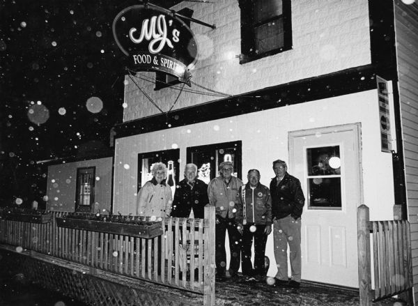 "With snowflakes in the air, we stop in at MJ's bar and restaurant in Brownsville, WI." From left to right; Shirley Widmer, Ralph Widmer, John Bodden, Rudy Heinecke, and Ralph "Buddy" Ruecker.