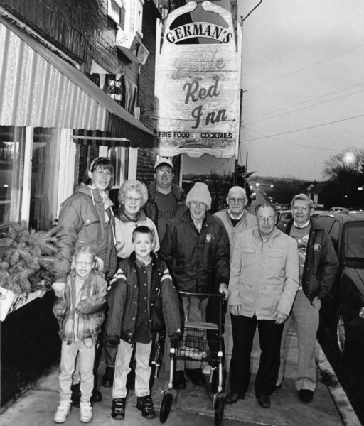 "Our group is joined by Larry & Kay Hren and their children, Parker & Carly at the Little Red Inn in St. Lawrence." Top row, from left to right; Kay Hren, Shirley Widmer, Larry Hren, Ralph Widmer, John Bodden, Rudy Heinecke, Ralph "Buddy" Ruecker. On bottom row, Carly and Parker Hren.