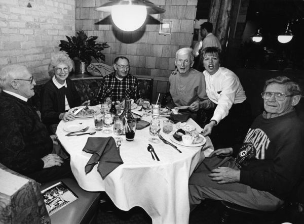 "Our waitress at Smith Bros. is Debbie, who tells us she is a grandma with four grandchildren. Surprise! Perch dinners are 16.95. Cod goes for $8.95."
 
From left to right; John Bodden, Shirley Widmer, Rudy Heinecke,Ralph Widmer, Debbie, and Ralph "Buddy" Ruecker.