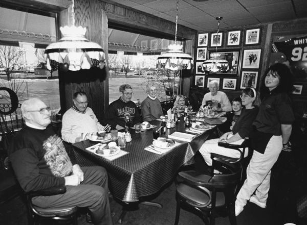 "This evening, Tanya Zimmerman, is our waitress, at Callahan's Grill & Bar. A perch plate (small order) is $8.95." From left to right; John Bodden, Rudy Heinecke, Ralph "Buddy" Ruecker, Shirley Widmer, Carly Hren, Ralph Widmer, Parker Hren, Kay Hren, and Tanya Zimmerman.