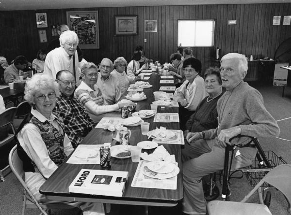 "At St. Theresa's parish hall our regulars are joined by "Buddy" Ruecker's friend Kitty Rogers & her mother Hilda Deamer (next to Ralph). Lucille Lux is at the left. A two-piece Cod plate was priced at $5.00."
