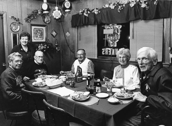 "Ann Koehnke is our waitress at the Amber Inn in Slinger, WI." From left to right; Ralph "Buddy" Ruecker, Ralph Widmer, Shirley Widmer, Rudy Heinecke, and John Bodden.