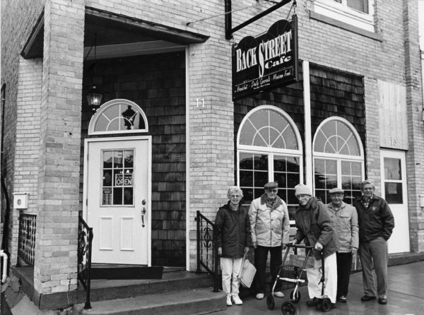 "Today we are at the Back Street Cafe on 11 North School St. in Mayville, WI." From left to right; Shirley Widmer, John Bodden, Ralph Widmer, Rudy Heinecke, and Ralph "Buddy" Ruecker.