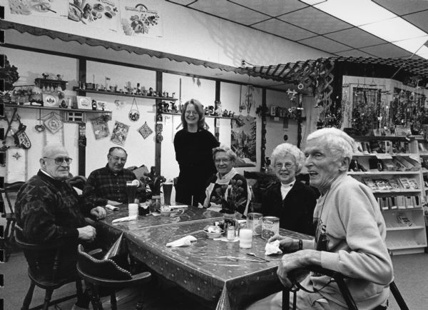"While dining at Sigrid's Bavarian Trail,our waitress Carrie Pobanz, entertains us by singing 'Edelweiss.' She and her family are moving to Branson, MO, in the hope of exploiting her vocal talents." From left to right; John Bodden, Rudy Heinecke, Carrie Pobanz, Ralph "Buddy" Ruecker, Shirley Widmer, and Ralph Widmer.