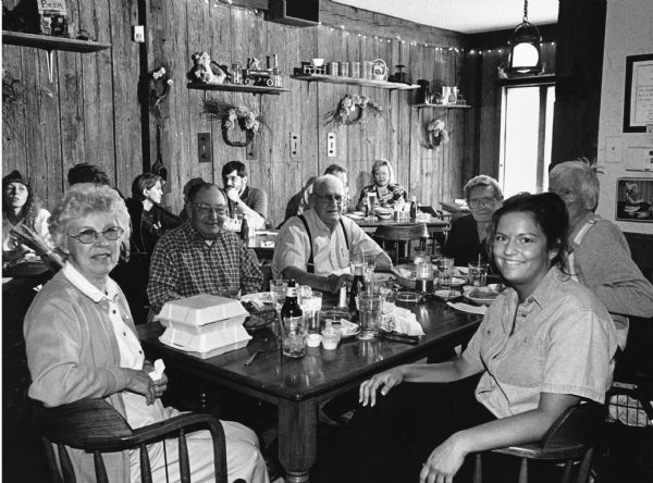 "At the Jail House Restaurant our waitress, Amy, informs us that she is a dental hygienist." Pictured (clockwise, starting on the left): Shirley Widmer, Rudy Heinecke, John Bodden, Ralph "Buddy" Ruecker, Ralph Widmer, and Amy.