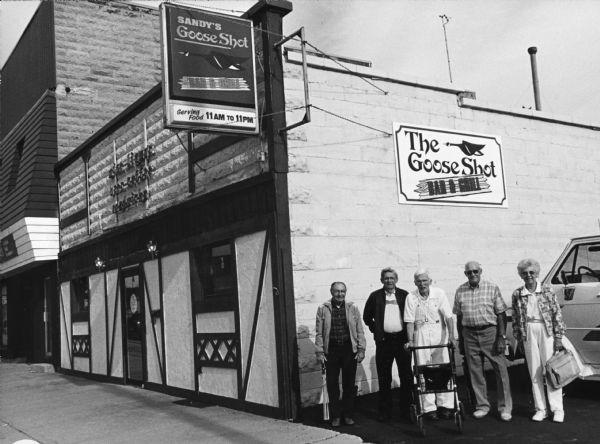 "Sandy's Goose Shot is at 105 E. Main St. in Waupun, WI." From left to right; Rudy Heinecke, Ralph "Buddy" Ruecker, Ralph Widmer, John Bodden, and Shirley Widmer.
