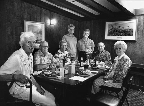 "At the Goose Shot in Waupun, Sandy Nummerdor and Bette Mocco take an intense interest in our Fish Fry pictures. We enjoy their food."