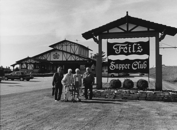"Feil's Supper Club, which has a German motif, is just south of Randolph on Hwy 73." From left to right; Ralph "Buddy" Ruecker, Ralph Widmer, Shirley Widmer, and John Bodden.