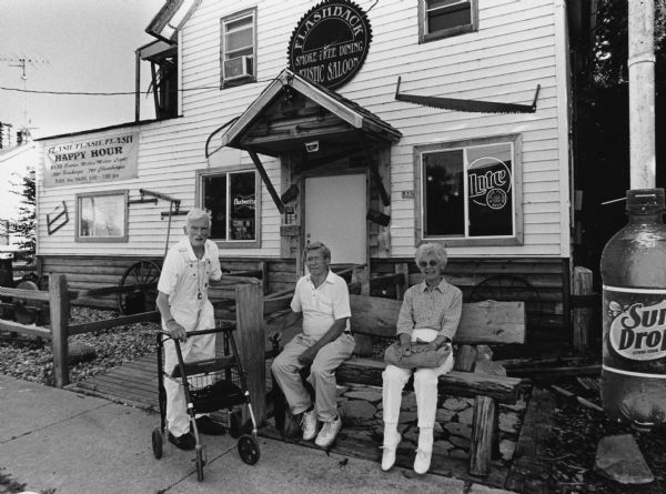 "Our group poses in front of the Flashback Rustic Saloon in Brownsville, WI." From left to right; Ralph Widmer, Ralph "Buddy" Ruecker, and Shirley Widmer.