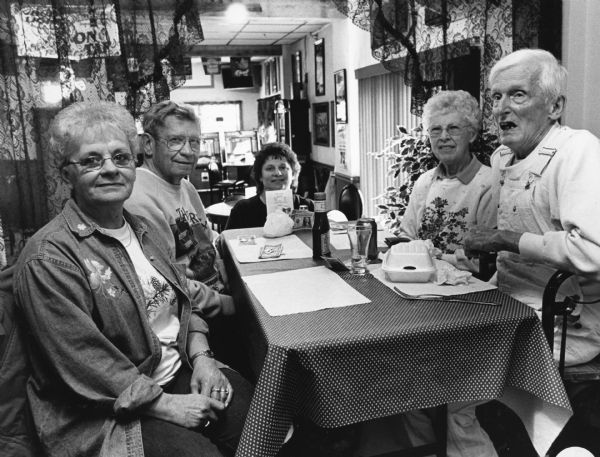 "At Cinder's, our waitress, Sandy, joins us at our table. In the back is the owner, Cindy." From left to right; Sandy, Ralph "Buddy" Ruecker, Cindy, Shirley Widmer, and Ralph Widmer.