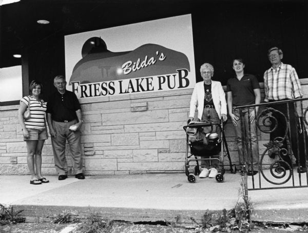 At the sign of Bilda's Friess Lake Pub; (from left to right) Kim Diorio, Carl Bernhard, Shirley Widmer, Alesha Hill, and Ralph "Buddy" Ruecker.