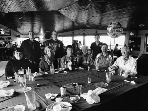 "Assembled around the table are:(standing left to right) J.P. Widmer, Buddy Ruecker, and our waitress Erica. (Seated left to right) Brenda Wilz, Quinn (friend of Logan), Logan Wilz, Shirley Widmer, Larry Hren, and Jim Widmer (with birthday balloon)."