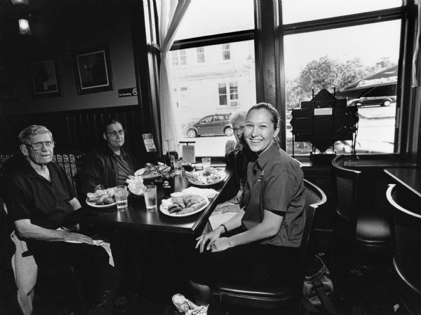 "Sarah was our waitress when we visited Tello's in Port Washington." From left to right; Ralph "Buddy" Ruecker, John P. Widmer, Shirley Widmer, and Sarah."
 
