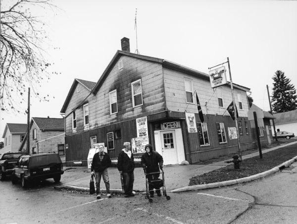 "This is Crabby Joe's Pub and Grill. When we visited this place on January 16, 2004, it was known as Schuyler Street Pub, in Uptown Neosho. The address is 212 Schuyler Street." From left to Right, John P. Widmer, Ralph "Buddy" Ruecker, and Shirley Widmer.